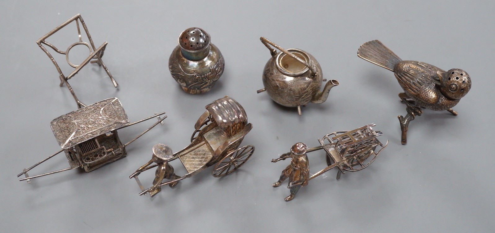 Six assorted miniature white metal items including a Chinese tea kettle on stand (lacking lid), height 93mm, maker CS, a similar rickshaw with driver, maker CH, a Chinese condiment and three other items.